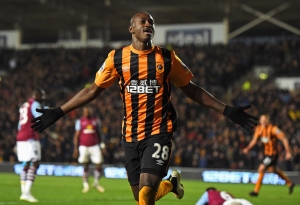 HULL, ENGLAND - FEBRUARY 10:  Dame N'Doye of Hull City celebrates after scoring is team's second goal during the Barclays Premier League match between Hull City and Aston Villa at the KC Stadium on February 10, 2015 in Hull, England.  (Photo by Laurence Griffiths/Getty Images)